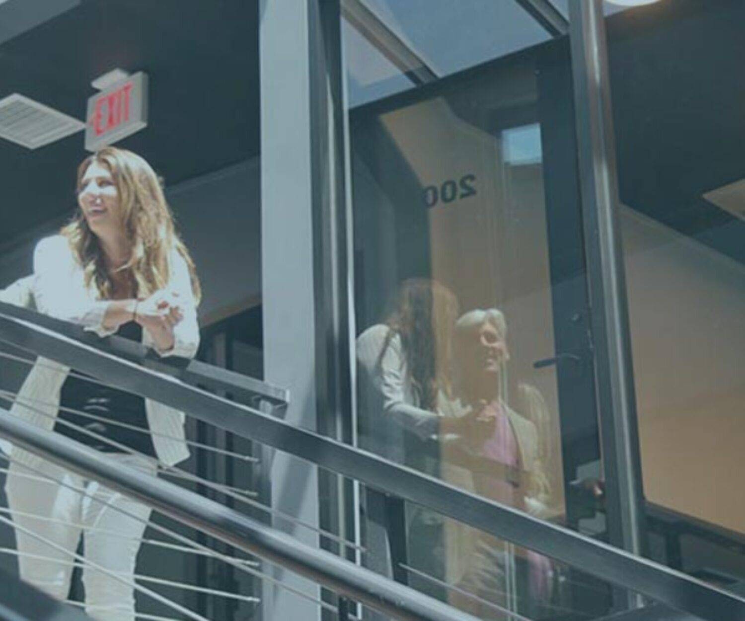 Jim Ellis and Lauren Fehlhaber stand on the stairway of The Film Hub