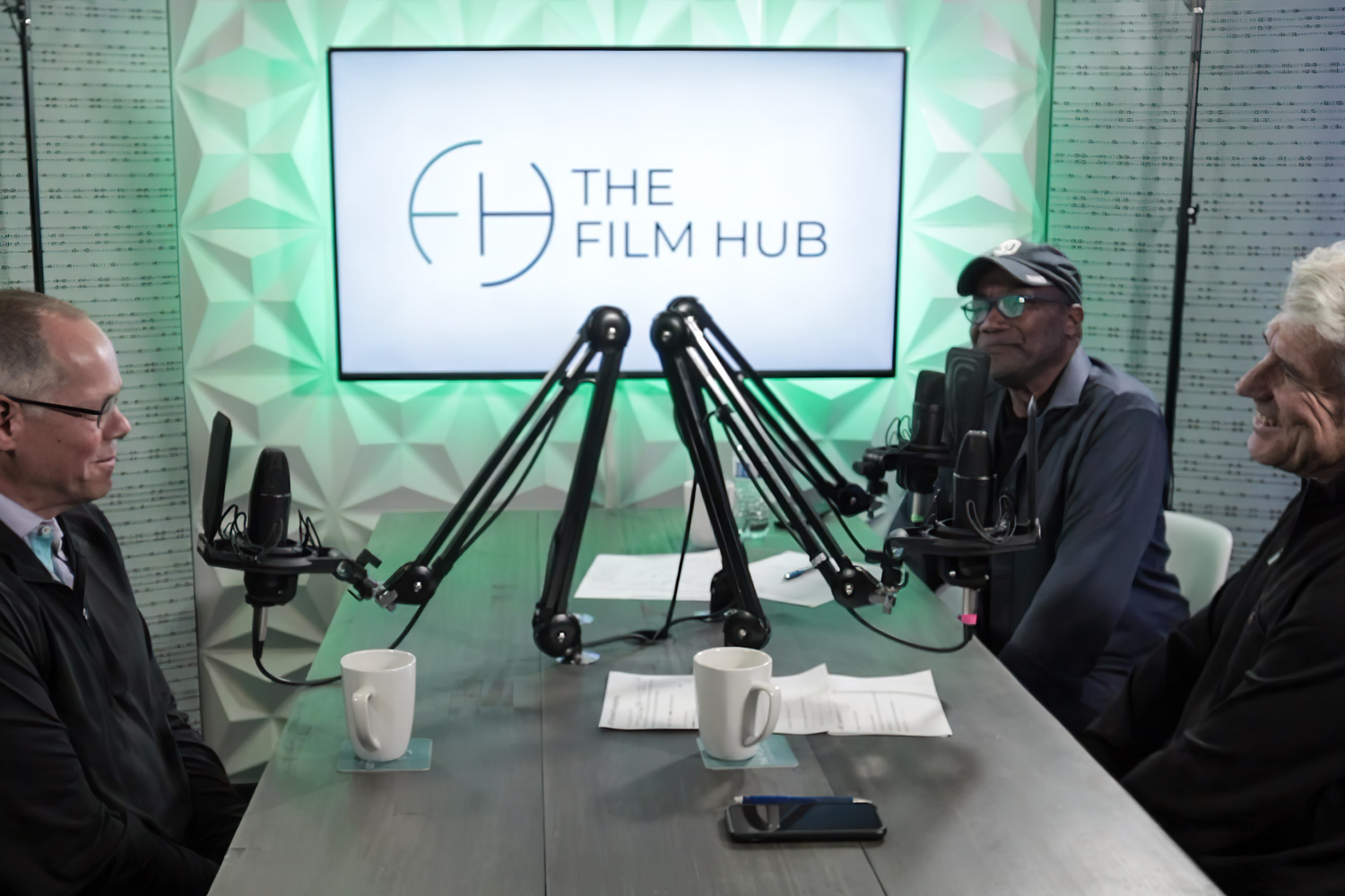 Jeff Deverett sits across Jim Ellis and Elias Acosta at The Film Hub podcast studio