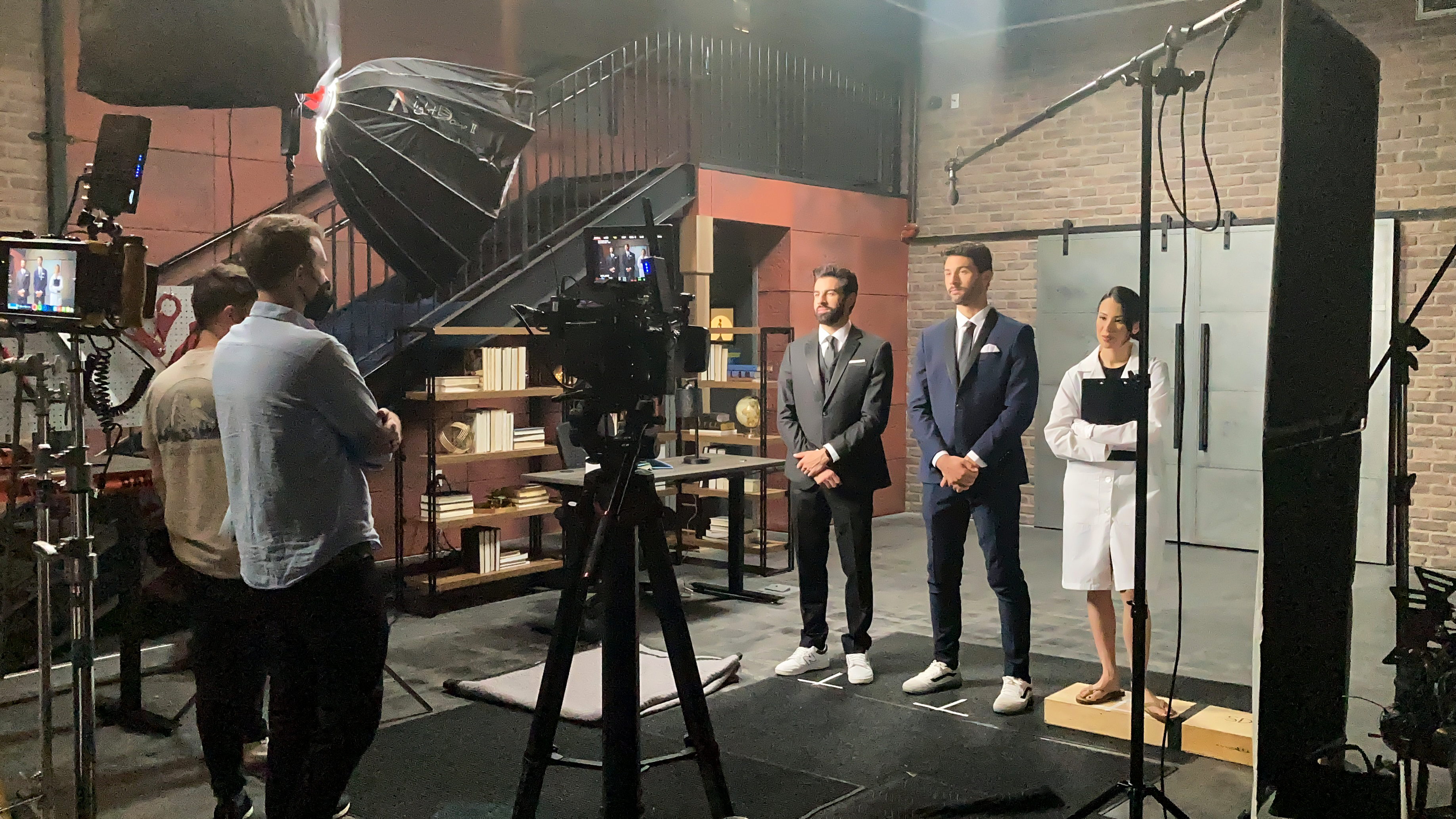 3 actors stand before a camera and lights as they shoot a commercial for a personal hygiene commercial