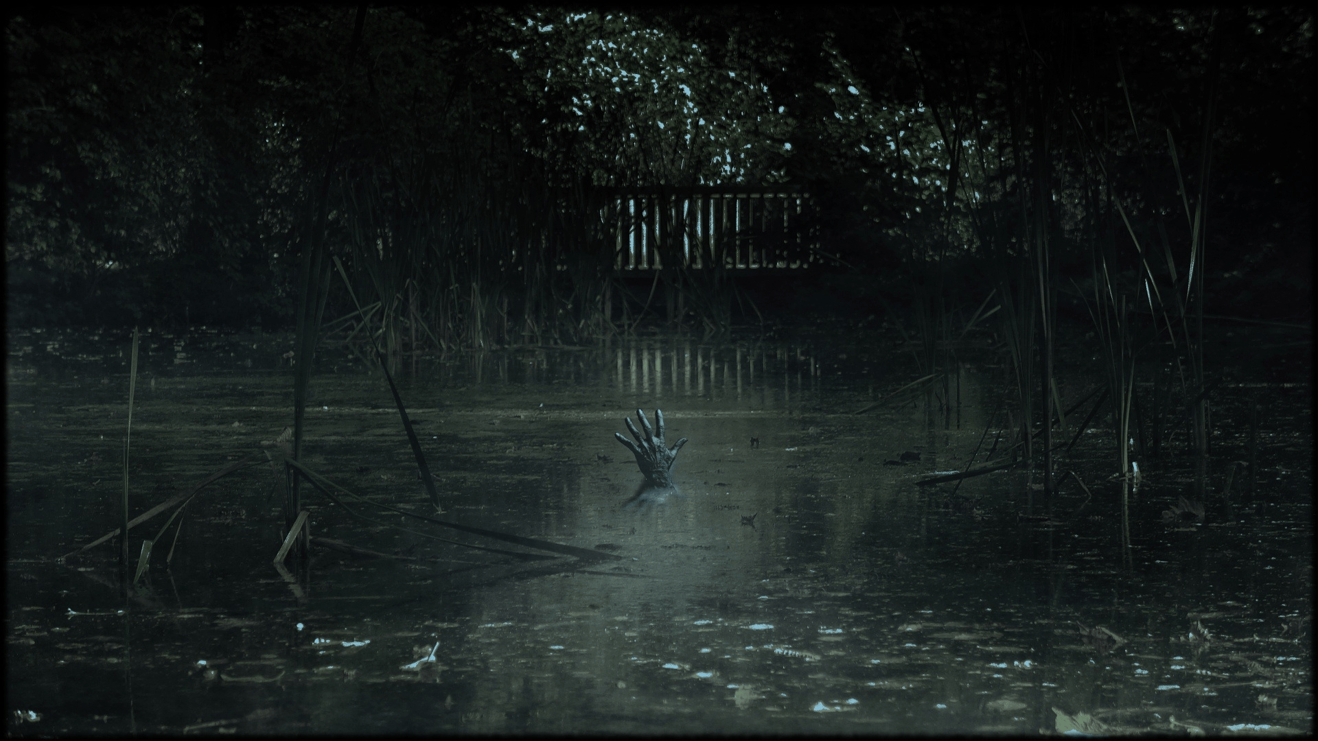 A dark hand emerges from a swamp