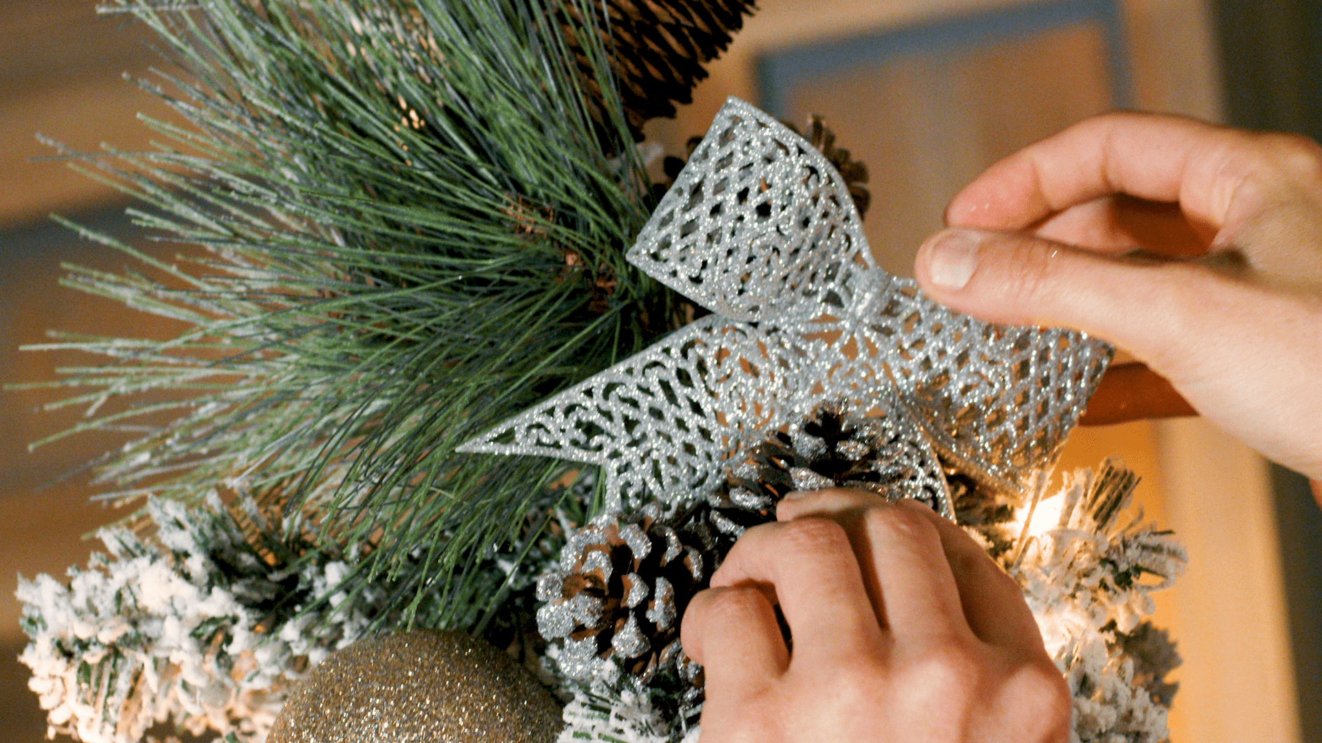 Lauren finalizes the christmas topper using pine needles and pine cones