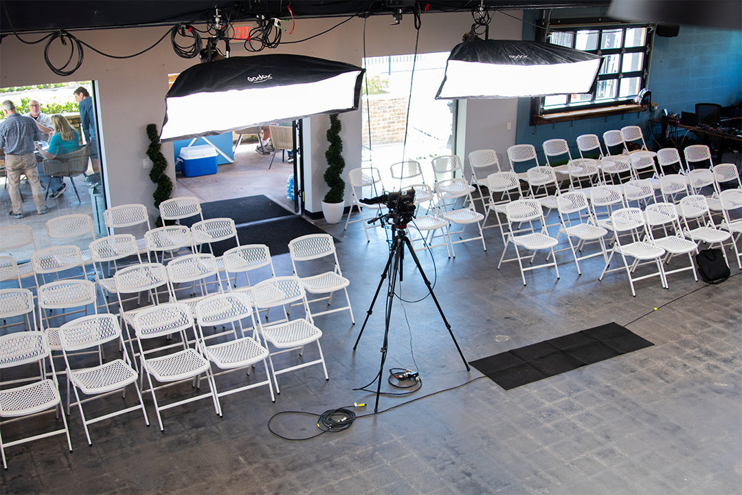 multiple chairs are set up for a speaking event at The Film Hub