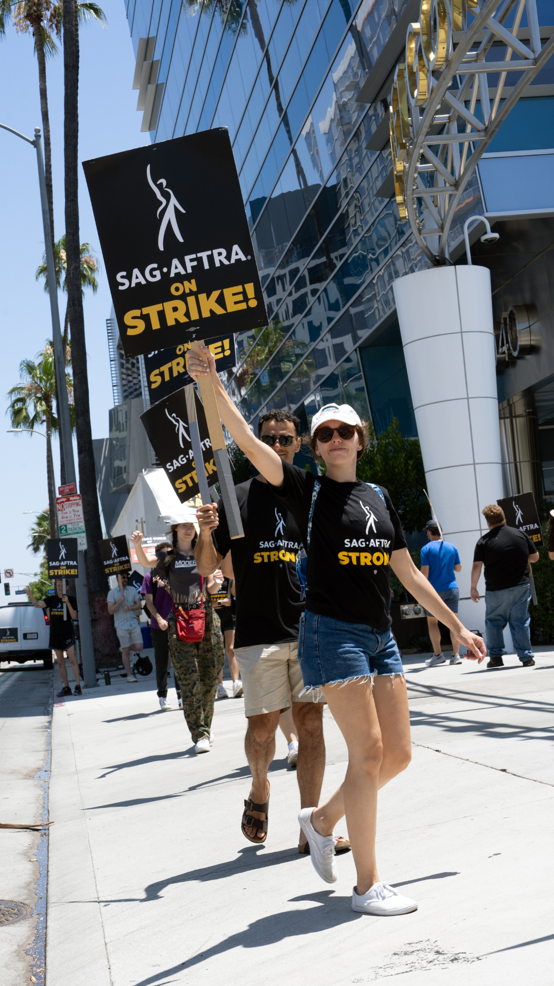 a lady holding a sign in support of the SAG-AFTRA