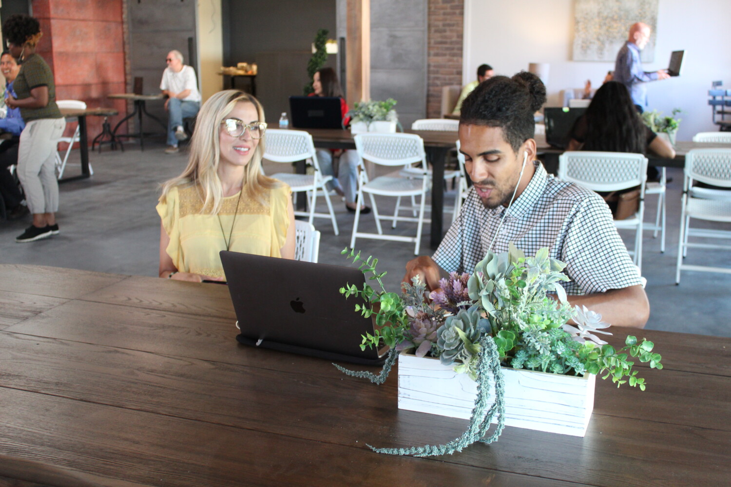 2 people working side by side at The Film Hub coworking space