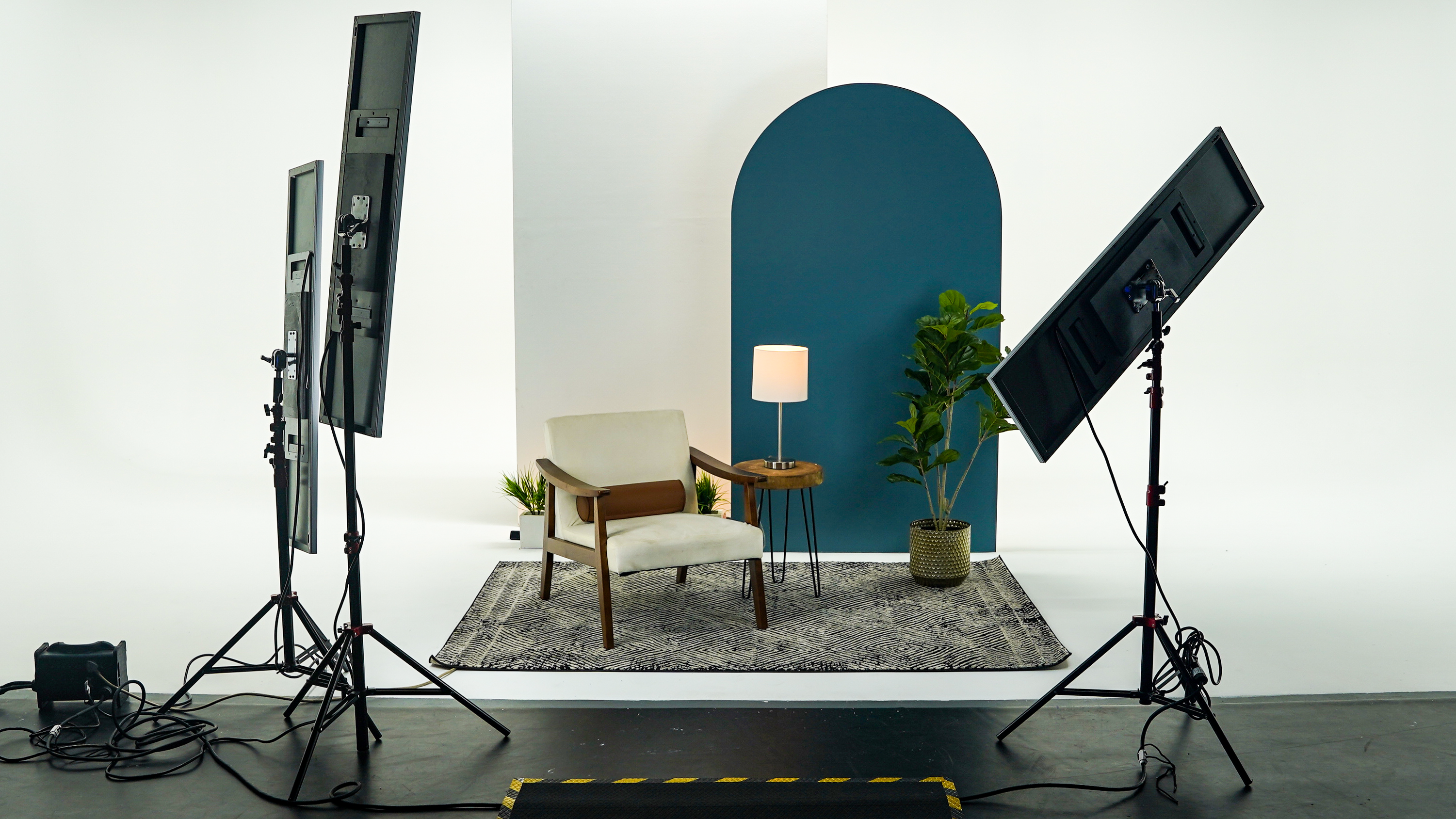 Modern interview or lifestyle shoot setup at The Film Hub, featuring soft lighting panels, a white cyclorama backdrop, contemporary furniture, and decorative props — ideal for brand interviews, social media content, or product videos.