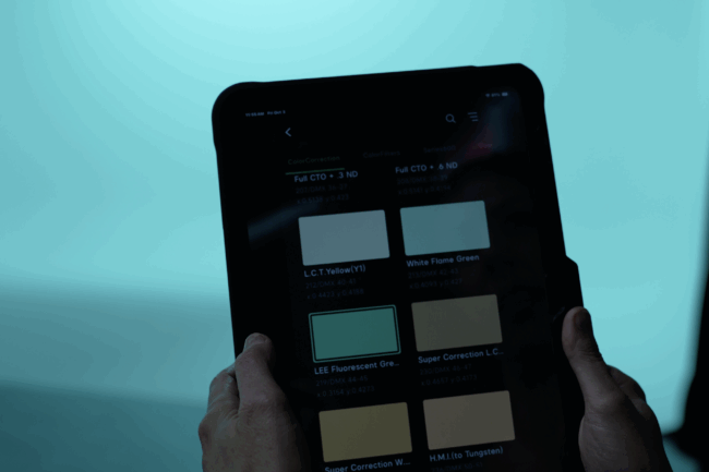 Close-up of a tablet screen showing color correction filter options for Aputure Nova P600c RGB LED lights, controlled during a production setup at The Film Hub’s Stage 2.
